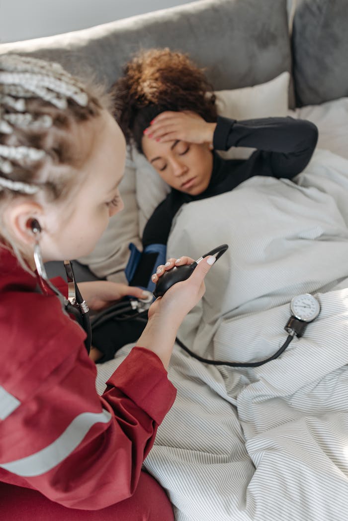 A healthcare professional checking a patients blood pressure at home.